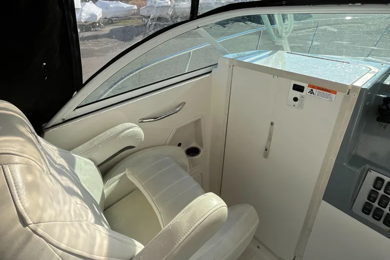 Slide: The Image of 2019 Striper 200 Walkaround boat interior with white seating and control panel. - 16