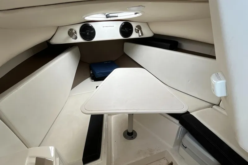 Slide: The Image of 2019 Striper 200 Walkaround cabin interior with table and seating. - 17