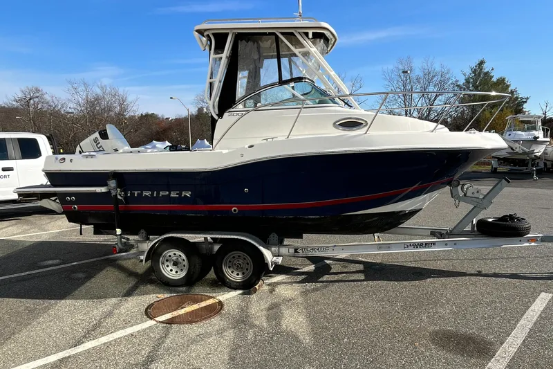 Slide: The Image of 2019 Striper 200 Walkaround boat on trailer in parking lot. - 2
