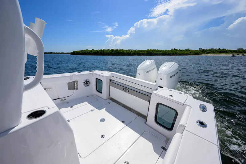 Slide: The Image of 2023 Sportsman Open 322 boat on water, featuring dual engines and spacious deck. - 14