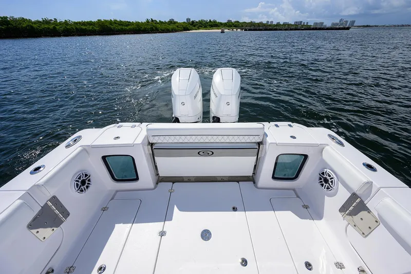 Slide: The Image of 2023 Sportsman Open 322 boat with dual engines on a calm water backdrop. - 15