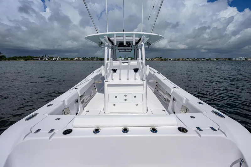 Slide: The Image of 2023 Sportsman Open 322 boat on calm water under cloudy sky. - 17