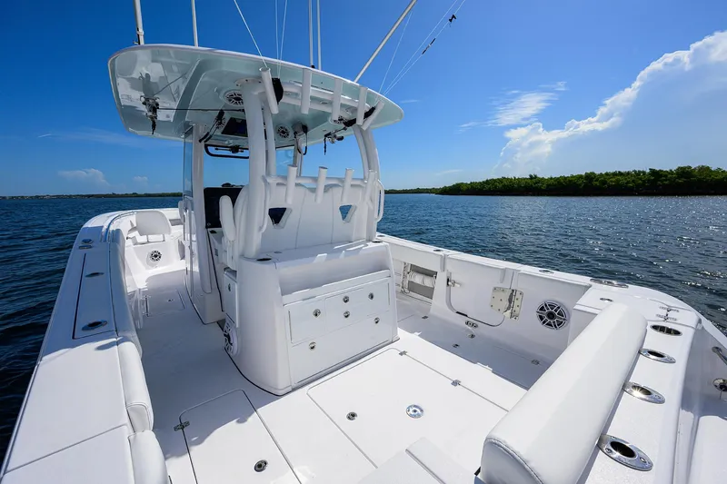Slide: The Image of 2023 Sportsman Open 322 boat interior on a sunny day, featuring spacious seating and sleek design. - 18