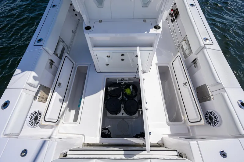 Slide: The Image of 2023 Sportsman Open 322 boat interior with storage compartments and seating. - 20