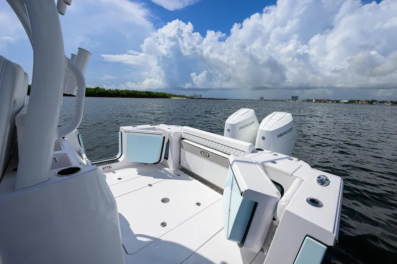 Slide: The Image of 2023 Sportsman Open 322 boat on water, featuring dual engines and spacious deck. - 23
