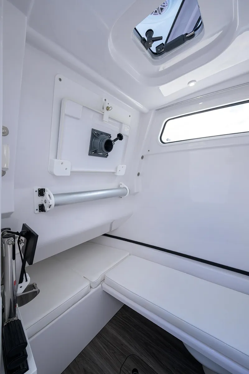 Slide: The Image of Interior cabin of 2023 Sportsman Open 322 boat, featuring sleek white design and window. - 27
