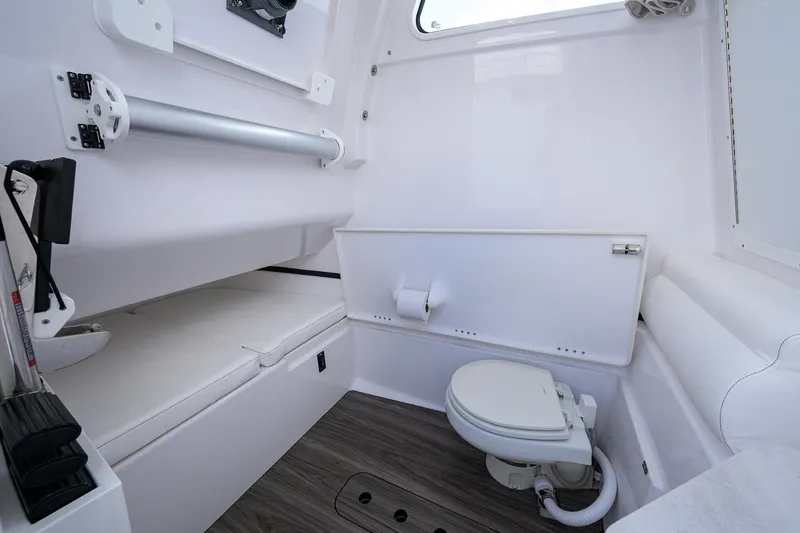 Slide: The Image of 2023 Sportsman Open 322 boat interior with toilet and seating area. - 31