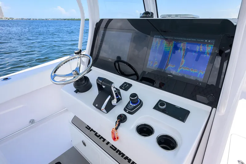 Slide: The Image of 2023 Sportsman Open 322 boat dashboard with navigation controls and display. - 34