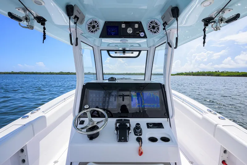 Slide: The Image of 2023 Sportsman Open 322 boat dashboard with navigation controls on open water. - 35