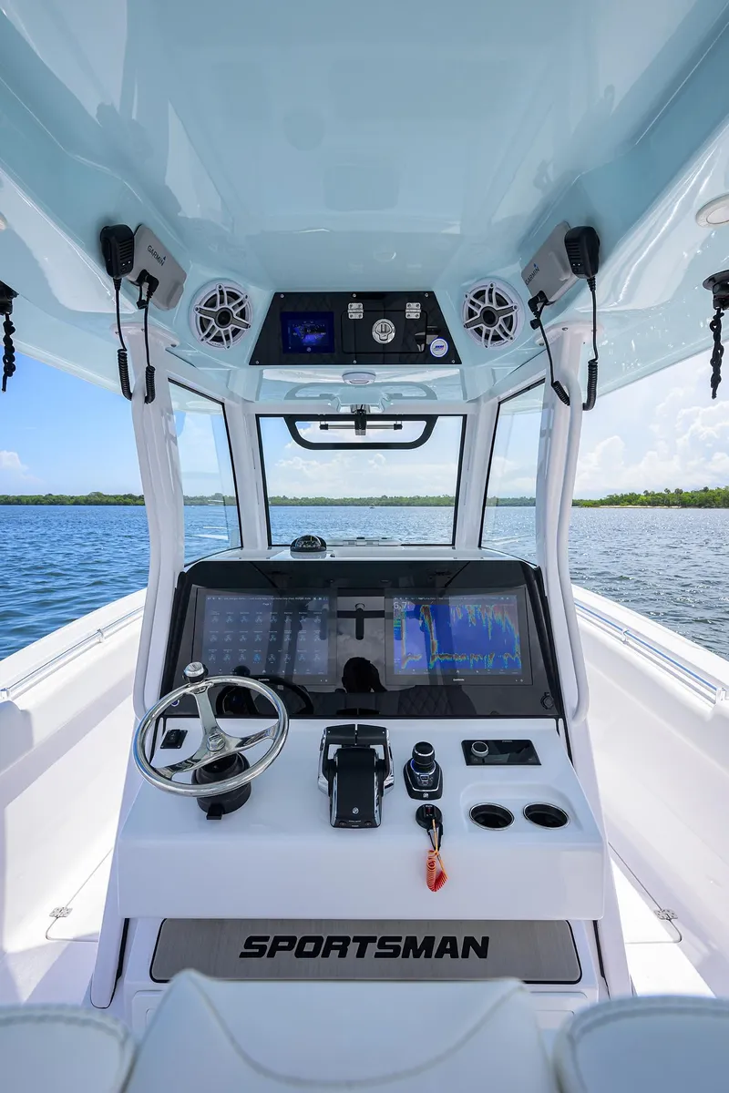 Slide: The Image of 2023 Sportsman Open 322 boat dashboard with advanced navigation system on open water. - 36