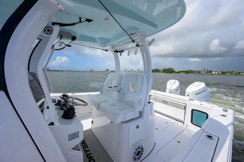 Slide: The Image of 2023 Sportsman Open 322 boat interior on water, featuring modern seating and controls. - 39