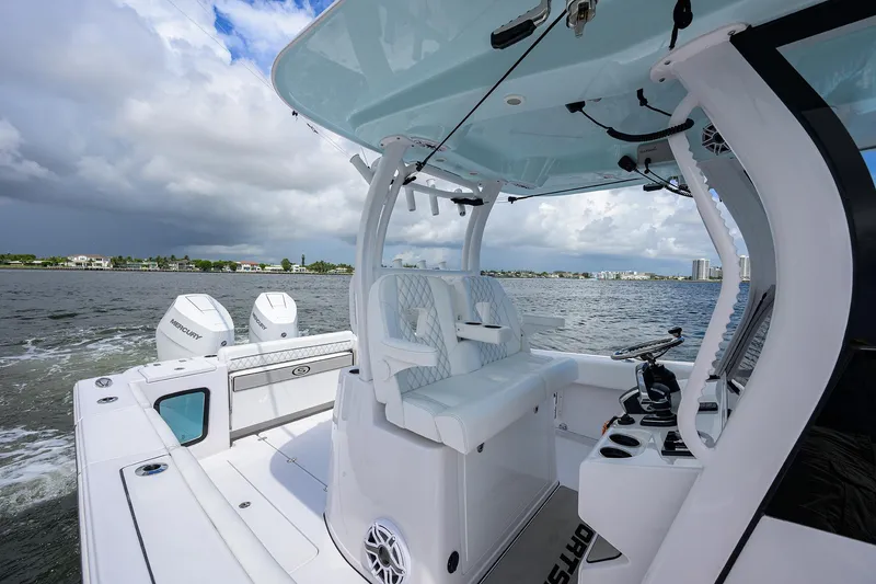 Slide: The Image of 2023 Sportsman Open 322 boat on water, featuring dual engines and sleek design. - 40