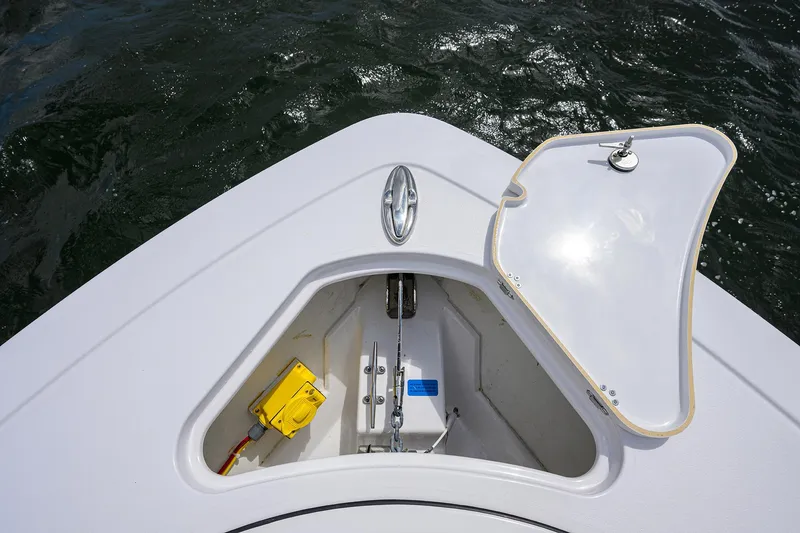 Slide: The Image of 2023 Sportsman Open 322 boat anchor compartment with open hatch on water. - 42