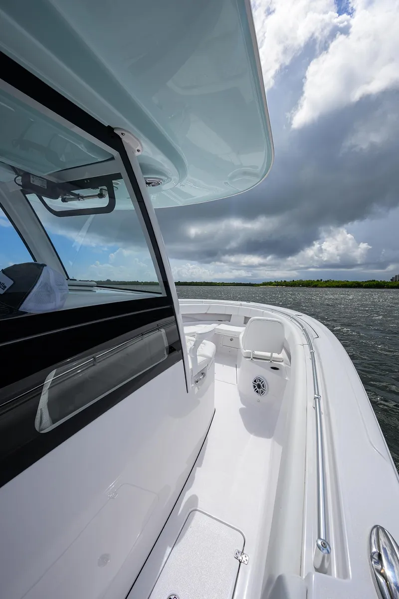 Slide: The Image of 2023 Sportsman Open 322 boat on water under cloudy sky. - 5