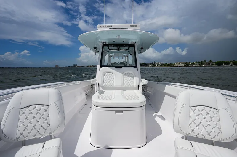 Slide: The Image of 2023 Sportsman Open 322 boat interior with white seating on a sunny day. - 8