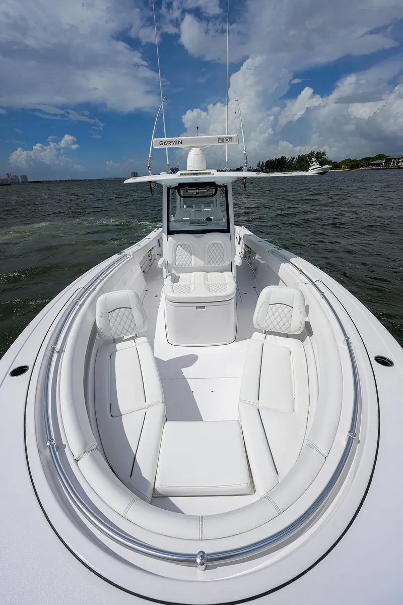 Slide: The Image of 2023 Sportsman Open 322 boat on water, showcasing sleek design and spacious seating. - 9