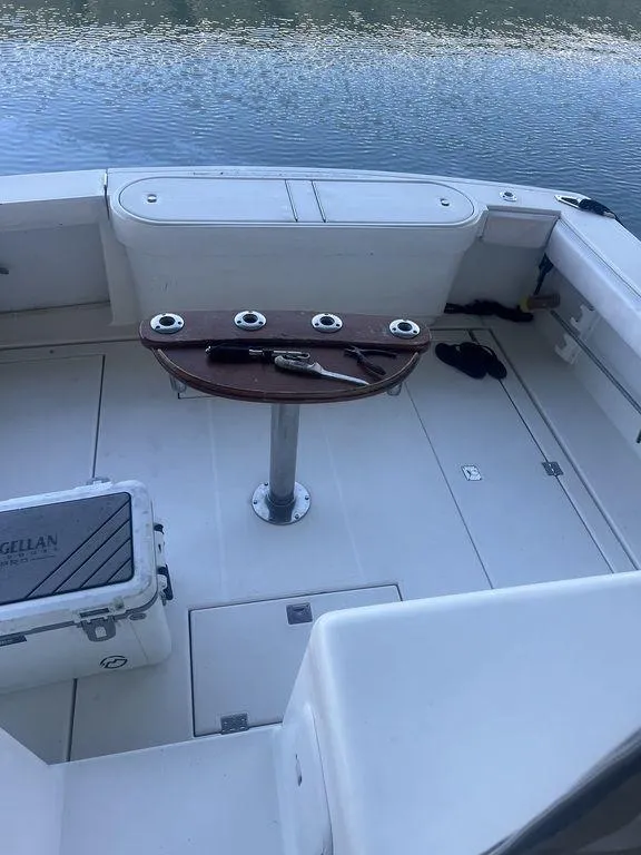 Slide: The Image of 2006 Rampage 38 Express boat deck with fishing rod holders and cooler. - 10