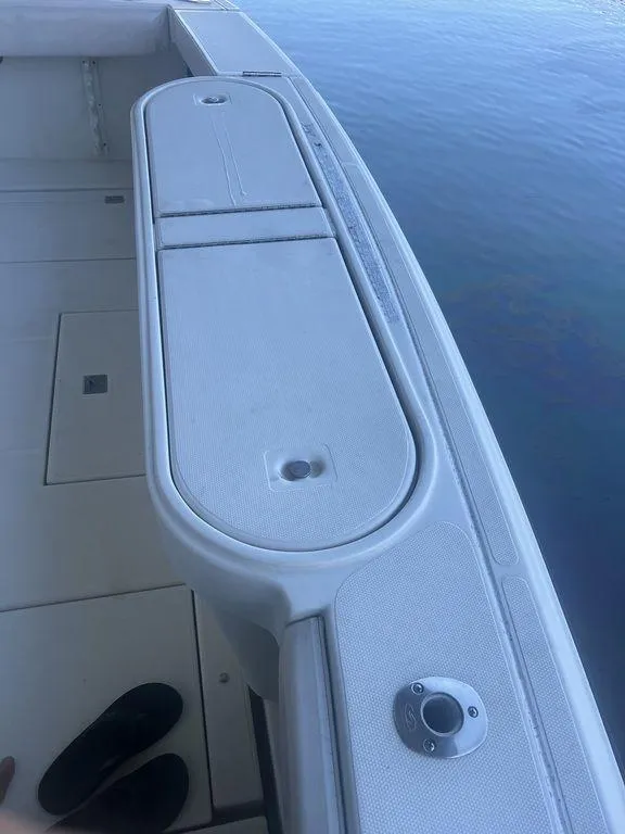 Slide: The Image of 2006 Rampage 38 Express boat deck with storage compartment and rod holder. - 11