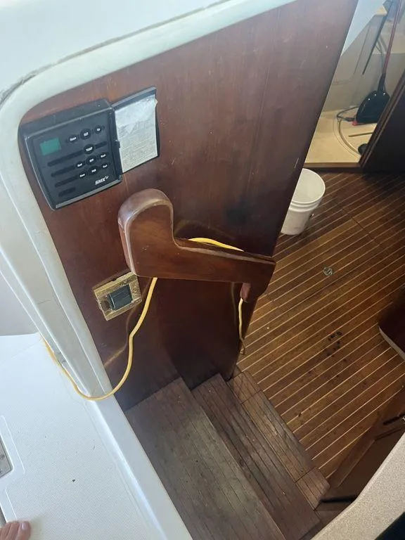 Slide: The Image of 2006 Rampage 38 Express boat interior with wooden stairs and control panel. - 13