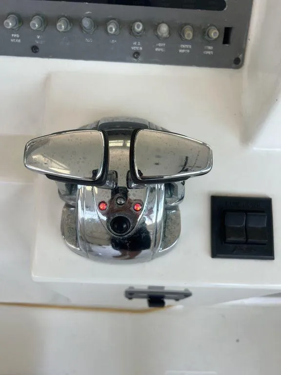 Slide: The Image of 2006 Rampage 38 Express boat throttle controls on dashboard. - 14