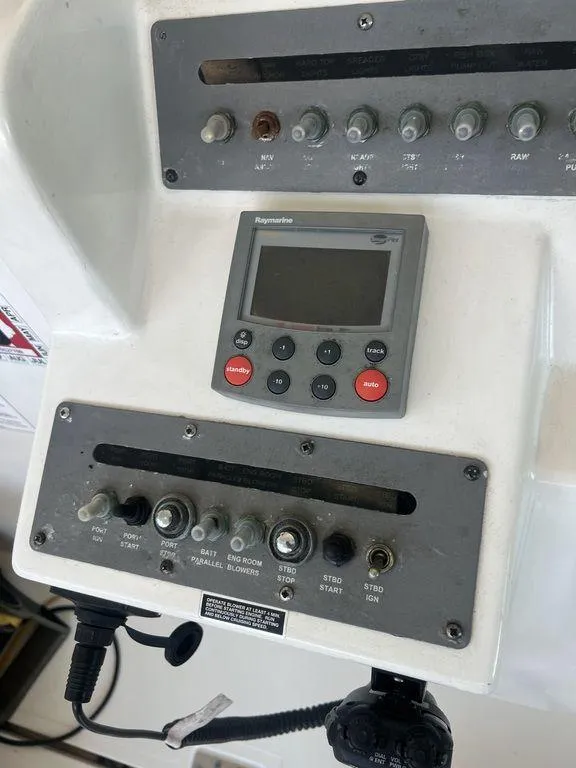 Slide: The Image of Control panel of a 2006 Rampage 38 Express boat with switches and display. - 15