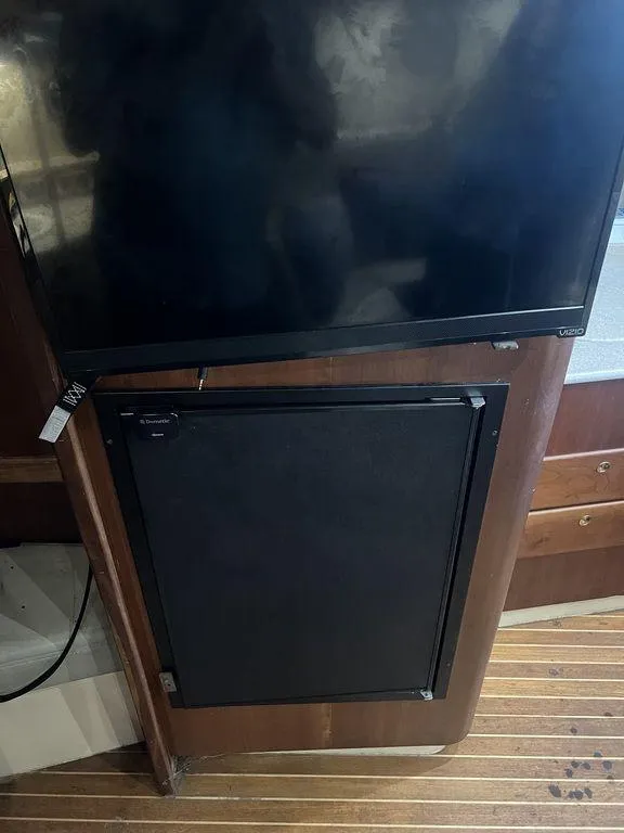 Slide: The Image of 2006 Rampage 38 Express interior with TV and cabinet on wooden flooring. - 18