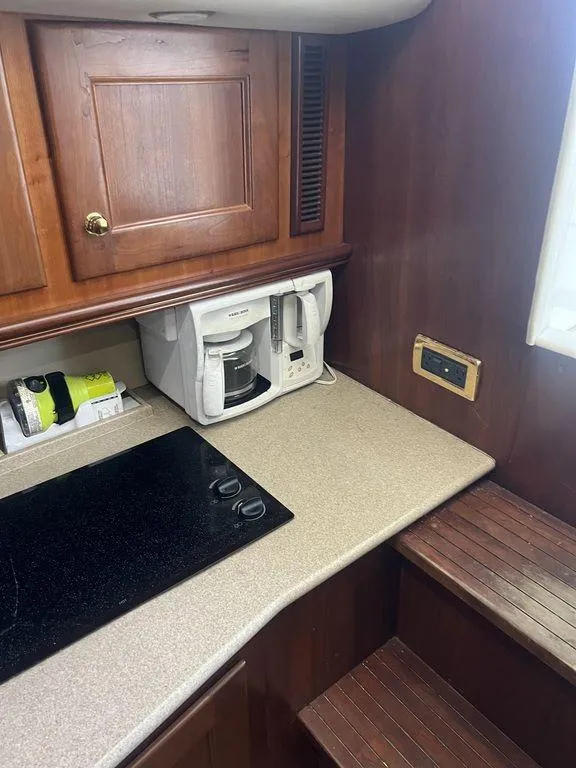 Slide: The Image of 2006 Rampage 38 Express boat kitchen with coffee maker and stovetop. - 19