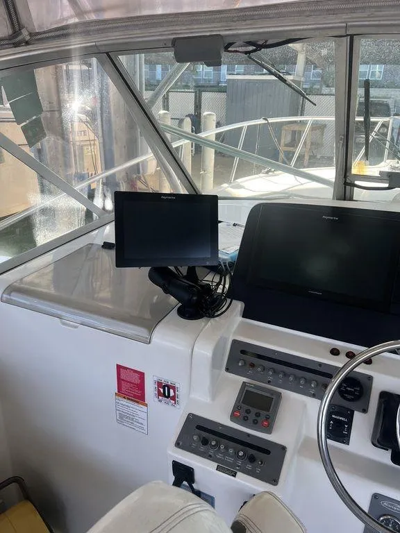 Slide: The Image of 2006 Rampage 38 Express boat helm with navigation equipment and controls. - 5