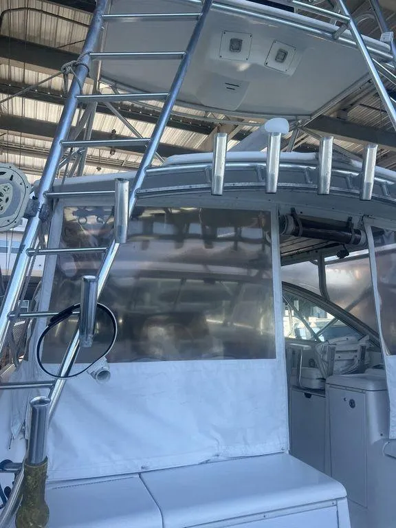 Slide: The Image of 2006 Rampage 38 Express boat with ladder and fishing rod holders in a marina. - 7