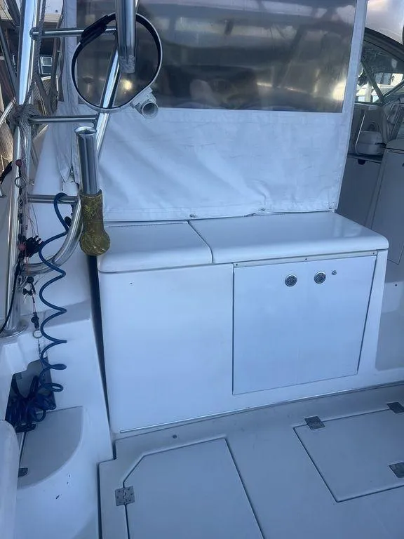 Slide: The Image of 2006 Rampage 38 Express boat interior with storage compartments and seating area. - 9