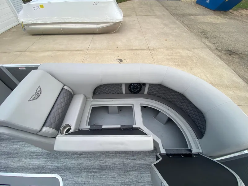 Slide: The Image of 2025 Bennington 23 LSB boat interior with gray seating and storage compartments. - 14