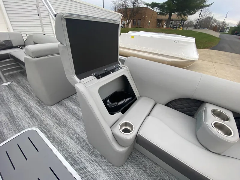 Slide: The Image of 2025 Bennington 23 LSB boat interior with gray seating and cup holders. - 16