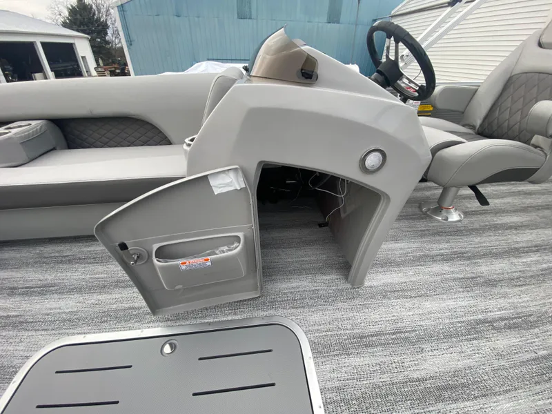 Slide: The Image of 2025 Bennington 23 LSB boat interior with open storage compartment and seating. - 19