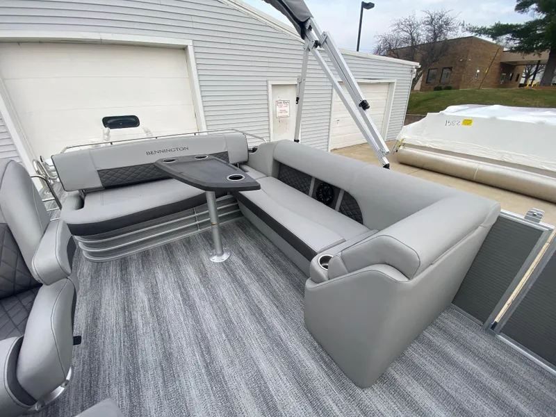 Slide: The Image of 2025 Bennington 23 LSB pontoon boat interior with gray seating and table. - 20