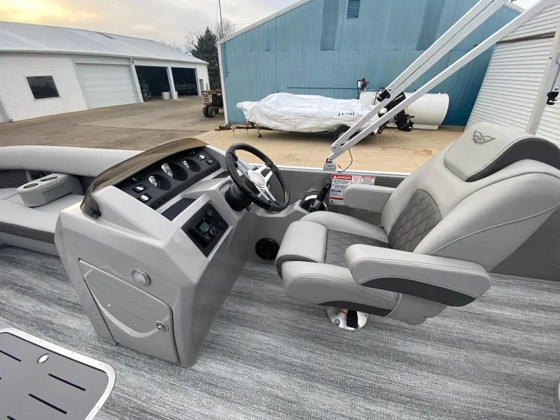 Slide: The Image of 2025 Bennington 23 LSB boat interior with steering wheel and captain's chair. - 21