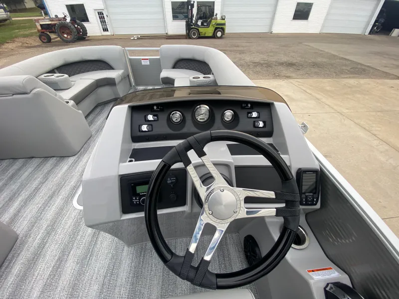 Slide: The Image of 2025 Bennington 23 LSB boat interior with steering wheel and dashboard controls. - 22