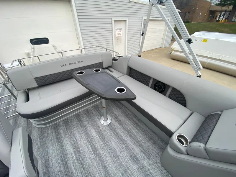 Slide: The Image of 2025 Bennington 23 LSB boat interior with gray seating and table. - 24