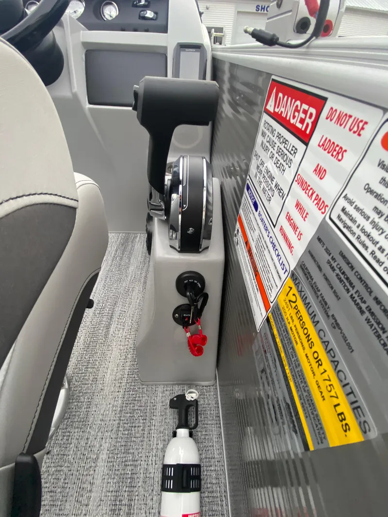 Slide: The Image of 2025 Bennington 23 LSB boat interior with control panel and safety warnings. - 26