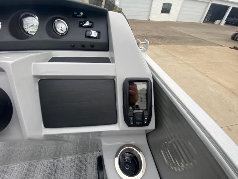 Slide: The Image of Dashboard of 2025 Bennington 23 LSB boat with control panel and cup holder. - 27