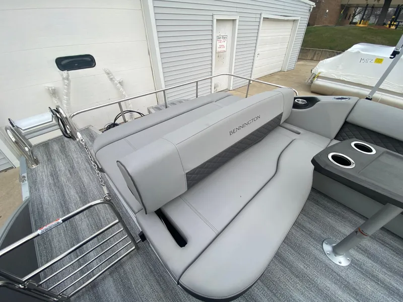 Slide: The Image of 2025 Bennington 23 LSB boat interior with gray seating and cup holders. - 28