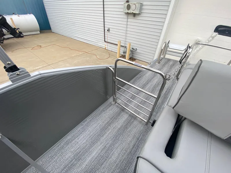 Slide: The Image of 2025 Bennington 23 LSB pontoon boat interior with gray seating and flooring. - 29