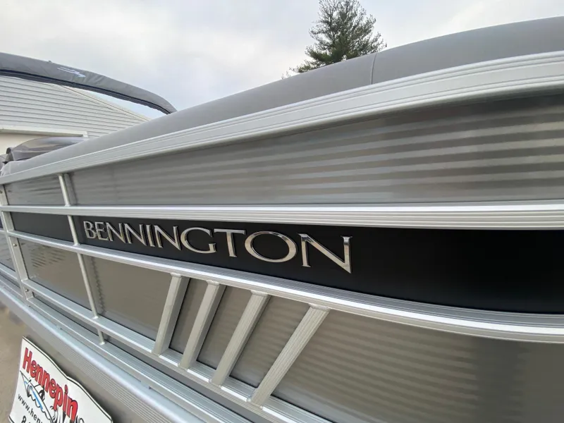 Slide: The Image of 2025 Bennington 23 LSB pontoon boat, sleek silver design, close-up view. - 36