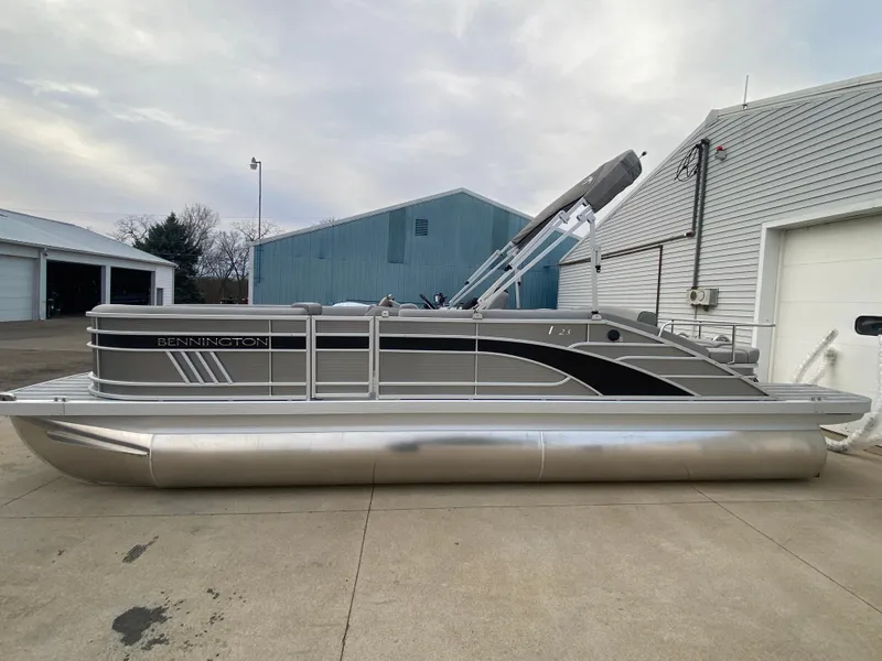 Slide: The Image of 2025 Bennington 23 LSB pontoon boat parked on concrete driveway. - 4