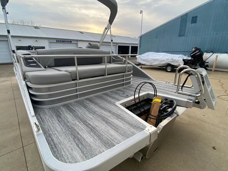 Slide: The Image of 2025 Bennington 23 LSB pontoon boat with spacious seating and modern design. - 6
