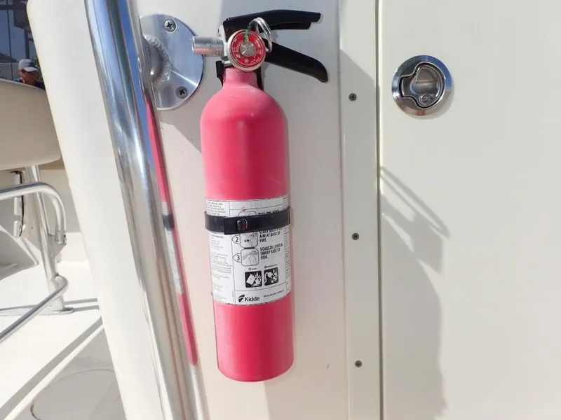 Slide: The Image of Red fire extinguisher mounted on 2016 Cobia 217 Center Console boat. - 27