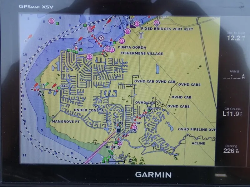 Slide: The Image of Garmin GPS display showing nautical map near Punta Gorda, Fishermen's Village, on a 2016 Cobia 217 Center Console. - 8