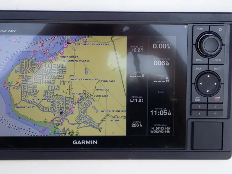 Slide: The Image of Garmin GPS display on 2016 Cobia 217 Center Console boat, showing navigation map and data. - 9