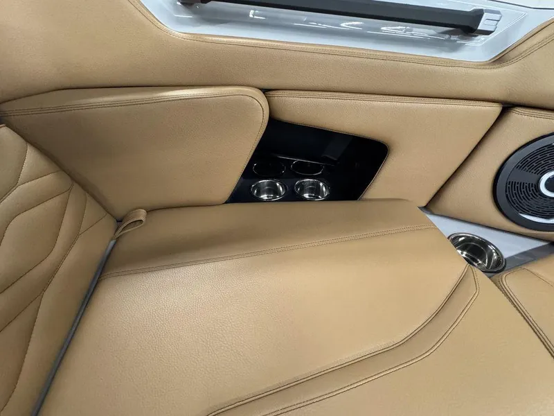 Slide: The Image of 2025 Supra SV 400 interior with tan leather seats and cup holders. - 17