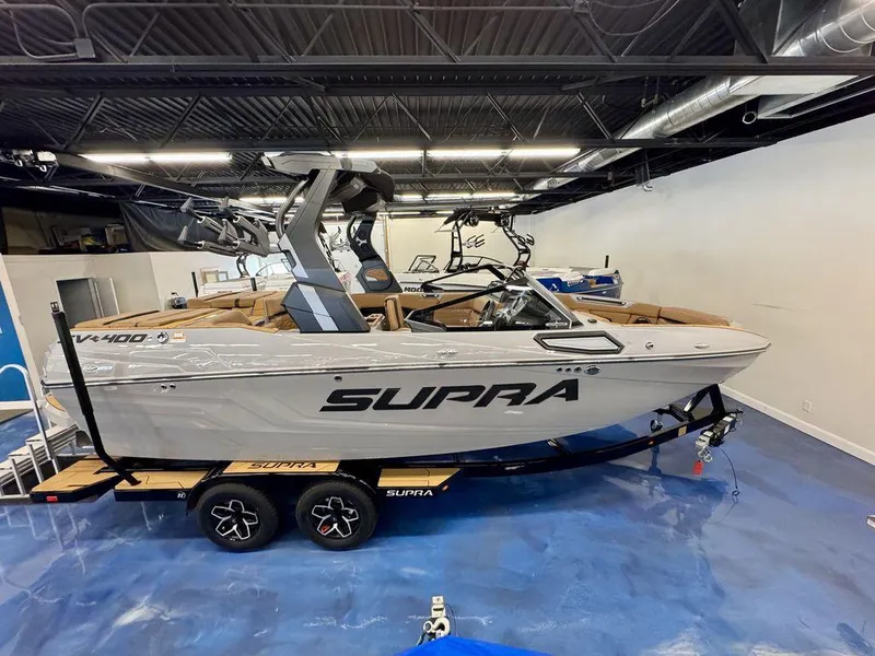 Slide: The Image of 2025 Supra SV 400 boat displayed indoors on a trailer. - 3