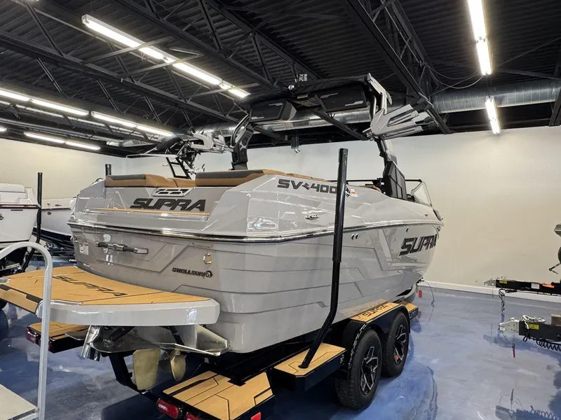 Slide: The Image of 2025 Supra SV 400 boat in showroom, featuring sleek design and modern amenities. - 5